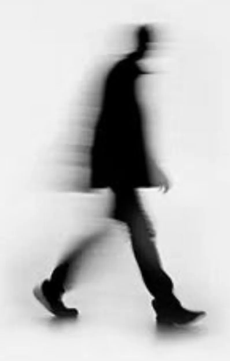 A black human figure blurred in motion across a white field.